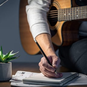 man-with-guitar-creates-music-plays-night-scaled.jpeg