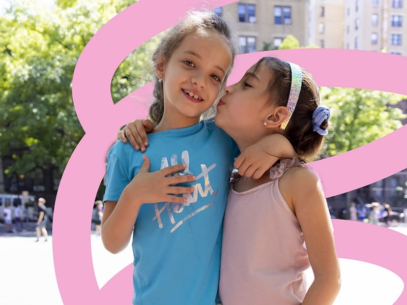 2 young girls embracing